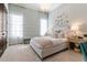 Serene bedroom featuring soft colors, elegant chandelier, and light-filtering curtains for a peaceful ambiance at 10143 Mattraw Pl, Golden Oak, FL 32836