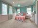 Charming bedroom with pink and blue color scheme, complemented by a whimsical chandelier and window treatments at 10143 Mattraw Pl, Golden Oak, FL 32836