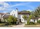 Beautiful two-story home featuring lush landscaping, a clay tile roof, and a circular brick driveway at 10143 Mattraw Pl, Golden Oak, FL 32836