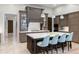 Modern kitchen featuring custom cabinetry, central island with seating and state-of-the-art appliances at 10143 Mattraw Pl, Golden Oak, FL 32836
