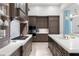 Gourmet kitchen featuring custom cabinetry, quartz countertops, and high-end stainless steel appliances at 10143 Mattraw Pl, Golden Oak, FL 32836