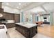 Open-concept kitchen flows into dining and living areas, featuring a large island and modern finishes at 10143 Mattraw Pl, Golden Oak, FL 32836