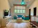 Relaxing living area with a turquoise sofa, colorful window treatments, and hardwood floors at 10143 Mattraw Pl, Golden Oak, FL 32836