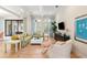 Bright and airy living room featuring hardwood floors, large windows, and a comfortable green sofa at 10143 Mattraw Pl, Golden Oak, FL 32836
