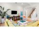 Bright and airy living room featuring hardwood floors, stylish decor, and a comfortable green sofa at 10143 Mattraw Pl, Golden Oak, FL 32836