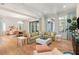 Bright and airy living room featuring hardwood floors, large windows, and a comfortable green sofa at 10143 Mattraw Pl, Golden Oak, FL 32836