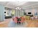 Bright living room featuring hardwood floors, modern lighting, and seamless access to the outdoor living space at 10143 Mattraw Pl, Golden Oak, FL 32836