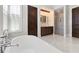 Elegant bathroom with a soaking tub, a large shower, and vanity with double sinks, for the ultimate spa experience at 10143 Mattraw Pl, Golden Oak, FL 32836