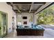 Cozy outdoor living area featuring a fireplace, TV, grill, ceiling fan, and comfortable seating at 10143 Mattraw Pl, Golden Oak, FL 32836