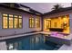 Gorgeous pool and jacuzzi area with a covered outdoor living space with a tv and grill at 10143 Mattraw Pl, Golden Oak, FL 32836