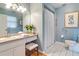 This bathroom has a large vanity, shower with a curtain, and updated toilet at 1073 Sadie Ln, Winter Garden, FL 34787