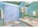 The bathroom has a sink, pink countertop, and a shower with a decorative curtain at 1073 Sadie Ln, Winter Garden, FL 34787