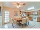 Dining area with a wooden table and chairs next to the kitchen, flooded with natural light at 1073 Sadie Ln, Winter Garden, FL 34787