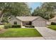 Charming single-story home with a well-manicured lawn and a two-car garage at 1073 Sadie Ln, Winter Garden, FL 34787