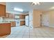 Spacious kitchen featuring white appliances, tile flooring, and ample cabinet space at 1073 Sadie Ln, Winter Garden, FL 34787