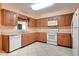 The kitchen features appliances, laminate counters, updated cabinetry, and tile floors at 1073 Sadie Ln, Winter Garden, FL 34787