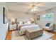Relax in this main bedroom featuring a king bed, ceiling fan, and lots of natural light at 1073 Sadie Ln, Winter Garden, FL 34787