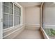 Enclosed porch with fresh neutral paint, neutral flooring and trimmed windows at 1073 Sadie Ln, Winter Garden, FL 34787