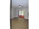 This bedroom features wood-look floors, ceiling fan and access to the enclosed lanai via sliding doors at 1102 Winter Springs Blvd, Winter Springs, FL 32708