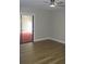 A serene bedroom featuring wood-look floors, neutral walls and access to lanai via sliding glass doors at 1102 Winter Springs Blvd, Winter Springs, FL 32708