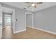 Bedroom featuring wood floors, ceiling fan, walk-in mirrored closet, and two entryways at 1102 Winter Springs Blvd, Winter Springs, FL 32708