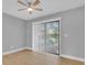 Bedroom featuring wood floors, ceiling fan, and sliding glass door at 1102 Winter Springs Blvd, Winter Springs, FL 32708