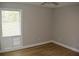 Neutral bedroom featuring wood-look flooring, louvered doors and a ceiling fan at 1102 Winter Springs Blvd, Winter Springs, FL 32708