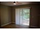 This bedroom has wood-look floors, ceiling fan and a sliding door with access to lanai at 1102 Winter Springs Blvd, Winter Springs, FL 32708