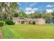 Landscaped lawn leads up to this beautiful single-story home with unique roof at 1102 Winter Springs Blvd, Winter Springs, FL 32708