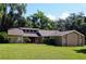Beautiful one-story home with a well-maintained lawn and mature trees providing shade at 1102 Winter Springs Blvd, Winter Springs, FL 32708