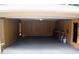 Spacious garage with wooden walls, overhead lighting, and workbench at 1102 Winter Springs Blvd, Winter Springs, FL 32708