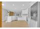 Kitchen with stainless appliances, light countertops, white cabinets, and wood floor at 1102 Winter Springs Blvd, Winter Springs, FL 32708