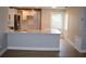 Newly renovated kitchen featuring a breakfast bar, stainless steel appliances, and custom white cabinets at 1102 Winter Springs Blvd, Winter Springs, FL 32708