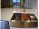 Kitchen sink with cutting board and drying rack on quartz countertops and stainless fixtures at 1102 Winter Springs Blvd, Winter Springs, FL 32708