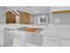 Stylish kitchen features stainless steel appliances, light countertops, a large sink, and wood floor at 1102 Winter Springs Blvd, Winter Springs, FL 32708