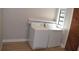 Bright laundry room with modern washer and dryer next to a window at 1102 Winter Springs Blvd, Winter Springs, FL 32708