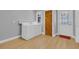 Laundry room featuring a washer and dryer, a door to the exterior, and wood flooring at 1102 Winter Springs Blvd, Winter Springs, FL 32708