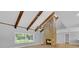 Spacious living room featuring a stone fireplace, wood beams, and lots of natural light at 1102 Winter Springs Blvd, Winter Springs, FL 32708