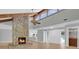 Open-concept living room with stone fireplace and natural light that flows into the kitchen at 1102 Winter Springs Blvd, Winter Springs, FL 32708