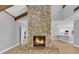 Charming living room with stone fireplace, vaulted ceiling, and views into the kitchen at 1102 Winter Springs Blvd, Winter Springs, FL 32708