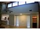 Spacious living room with vaulted ceilings, hardwood floors, and adjacent dry bar and white kitchen at 1102 Winter Springs Blvd, Winter Springs, FL 32708