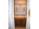 Custom wet bar tucked inside a closet, featuring wooden countertop, shelving, and charming floral accents at 1102 Winter Springs Blvd, Winter Springs, FL 32708
