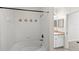 Clean white tiled tub and shower combination with decorative diamond accents at 12843 Madison Pointe # 208, Orlando, FL 32821