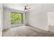 Bright bedroom with a sliding glass door leading to a private balcony, offering serene views and ample natural light at 12843 Madison Pointe # 208, Orlando, FL 32821