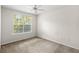 Bright bedroom featuring a neutral color palette and a sunny window at 12843 Madison Pointe # 208, Orlando, FL 32821