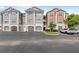Condominium buildings boast well-maintained landscaping and convenient parking, perfect for easy access to your new home at 12843 Madison Pointe # 208, Orlando, FL 32821
