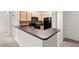 Functional kitchen with breakfast bar, black appliances, and ample cabinet space seamlessly connects to the dining area at 12843 Madison Pointe # 208, Orlando, FL 32821