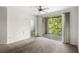 Carpeted living room with a sliding glass door to the outdoor balcony at 12843 Madison Pointe # 208, Orlando, FL 32821