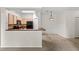 Open living space flows from kitchen to dining, creating an airy atmosphere perfect for entertaining at 12843 Madison Pointe # 208, Orlando, FL 32821