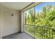 Peaceful screened porch offering a private view of mature trees and sky at 12843 Madison Pointe # 208, Orlando, FL 32821